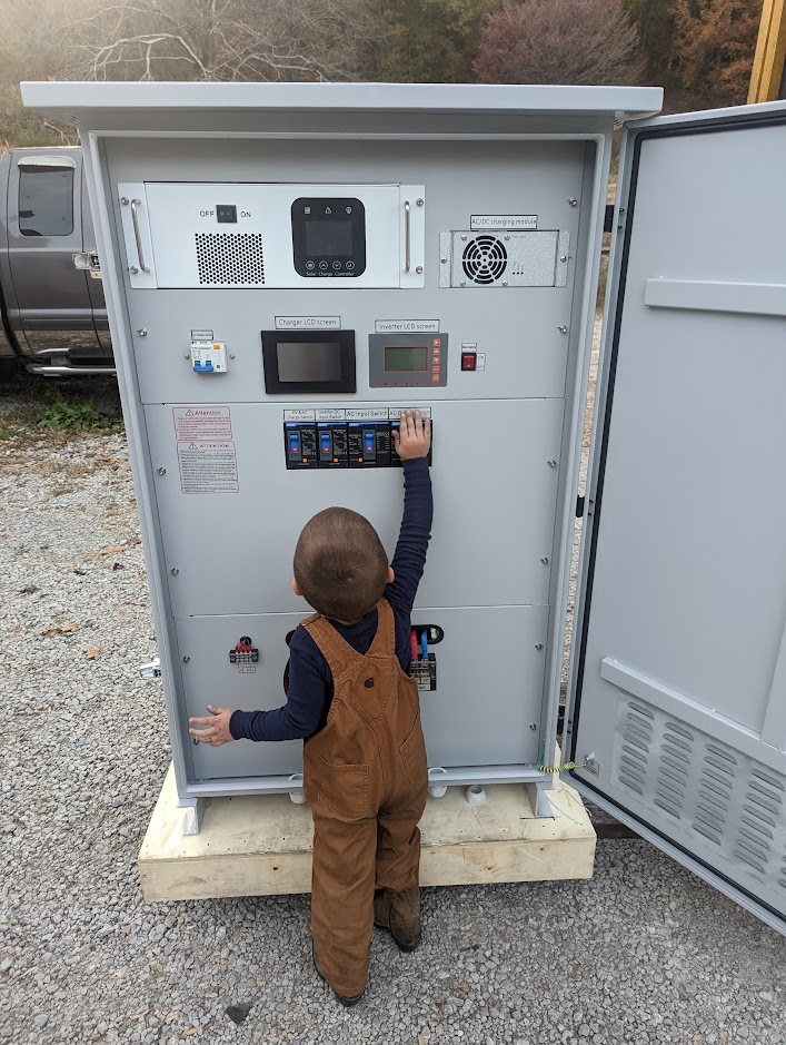 Cabinet on delivery day with a child at the breaker panel