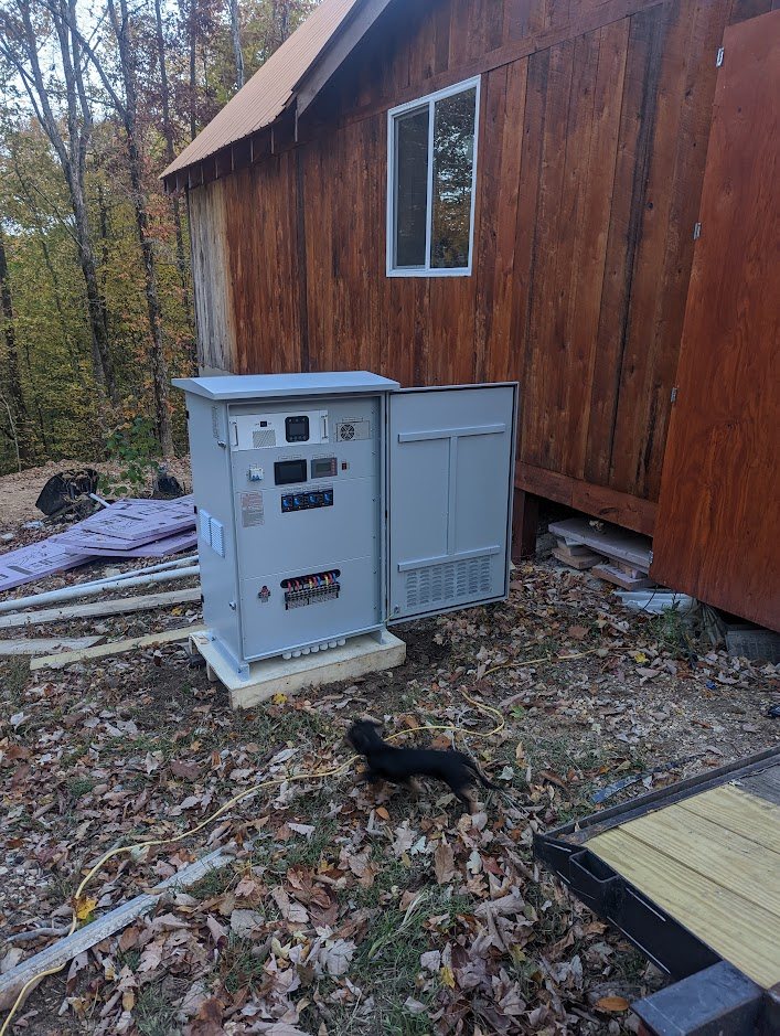 Cabinet placed outdoors beside a wooden cabin