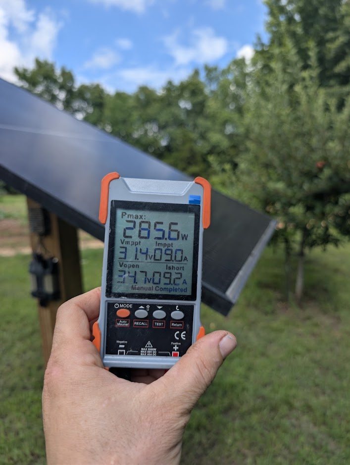 Handheld solar panel tester reading 285.6 watts