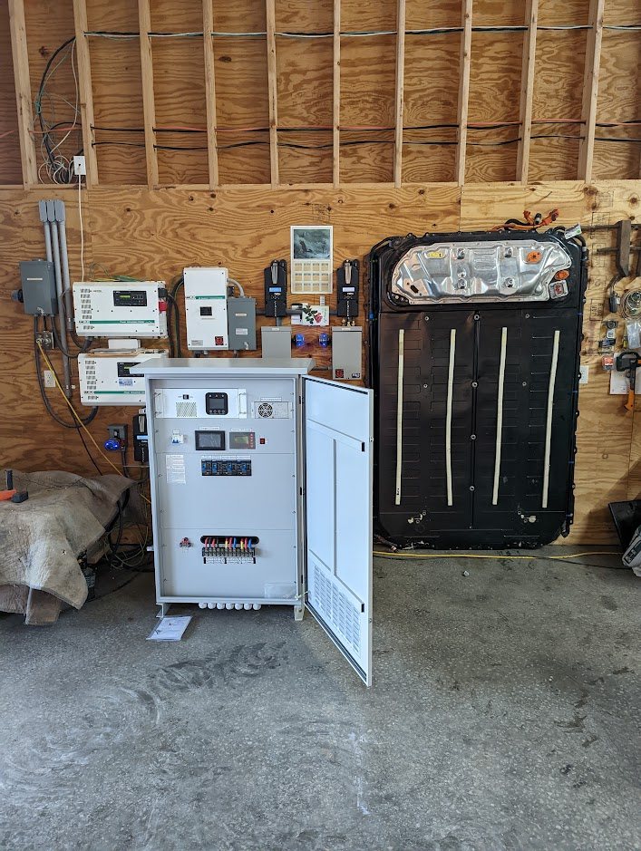 FES-20 cabinet next to a wall-mounted Tesla battery pack